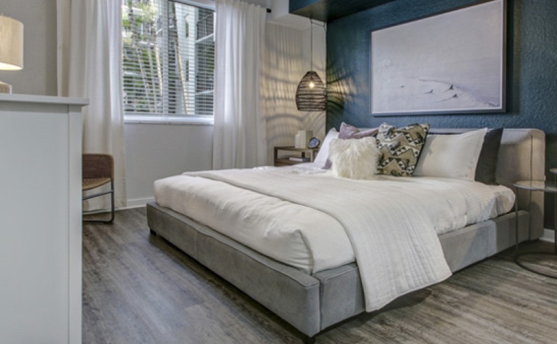 Spacious bedrooms with wood-inspired flooring